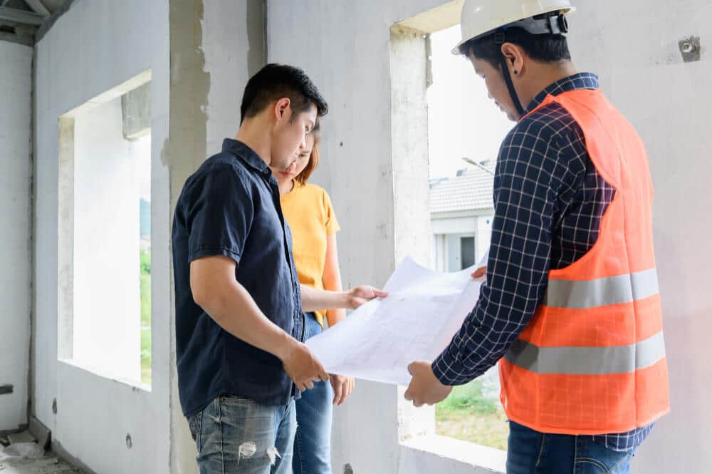 owner-new-house-inspection-with-engineer-architect-love-couple-village-project-estate-building 